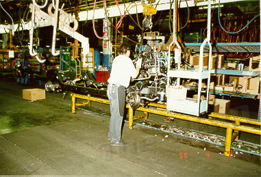 factory12.gif - Engine/Trans being mounted to chasis