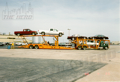 factory32.gif - A mixed load of pick ups, Impalas and Cadillacs about ready topull out.