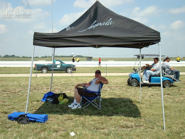 DSC00279.JPG - The 2009 Super Chevy Show ... what can I say ... it was windy. Just look at the canopy.Tony T is catching some shade ... and some wind. He won Modified Outstanding.